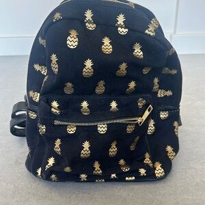 Black canvas with gold hardware and pineapples backpack